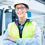 Worker in a hard hat in front of a truck
